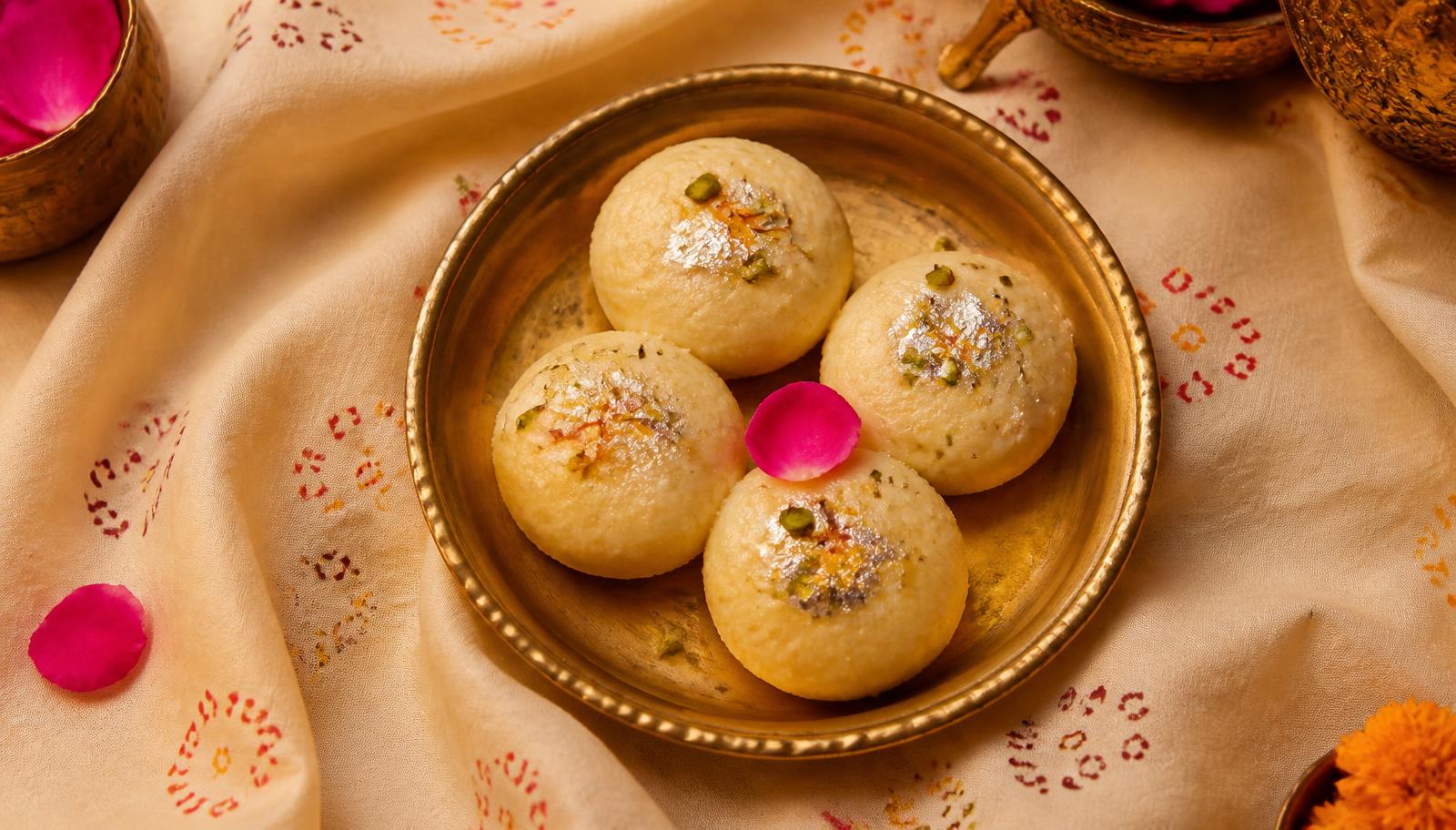 Authentic Gangapur City Kheer Mohan on a brass thali, garnished with saffron and pistachio